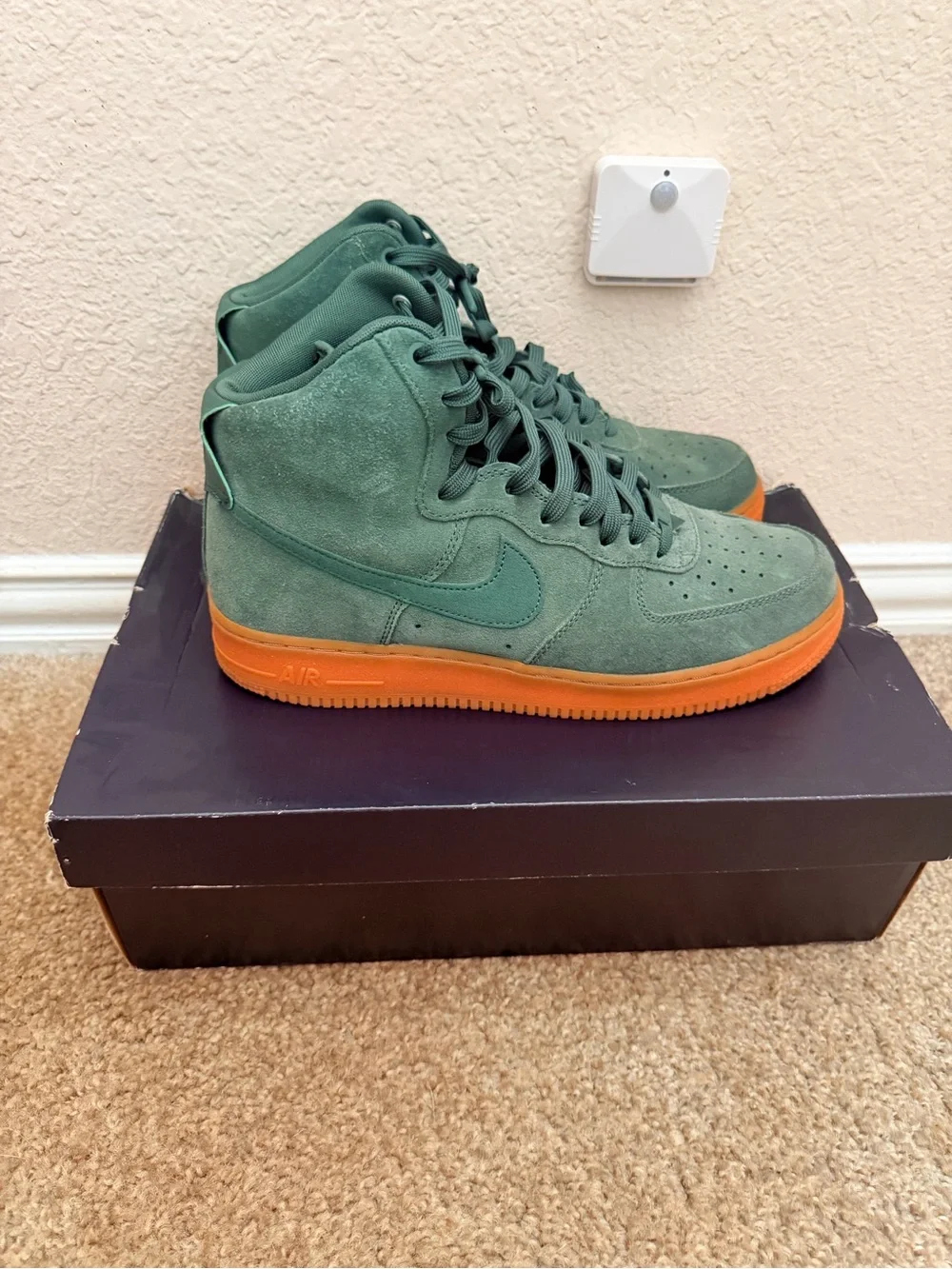 Shoebox on floor under wall sensor